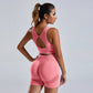 Woman wearing seamless pink yoga set women's vest and high waist shorts workout sportswear