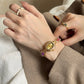 Women's agate bead bracelet watch with gold-tone analog dial and purple stone accents on alloy band