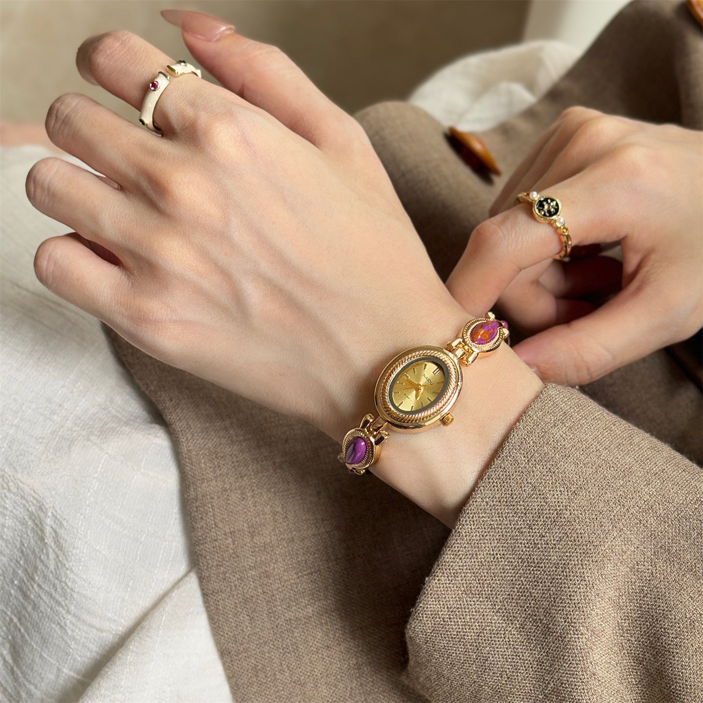 Women's agate bead bracelet watch with gold-tone analog dial and purple stone accents on alloy band