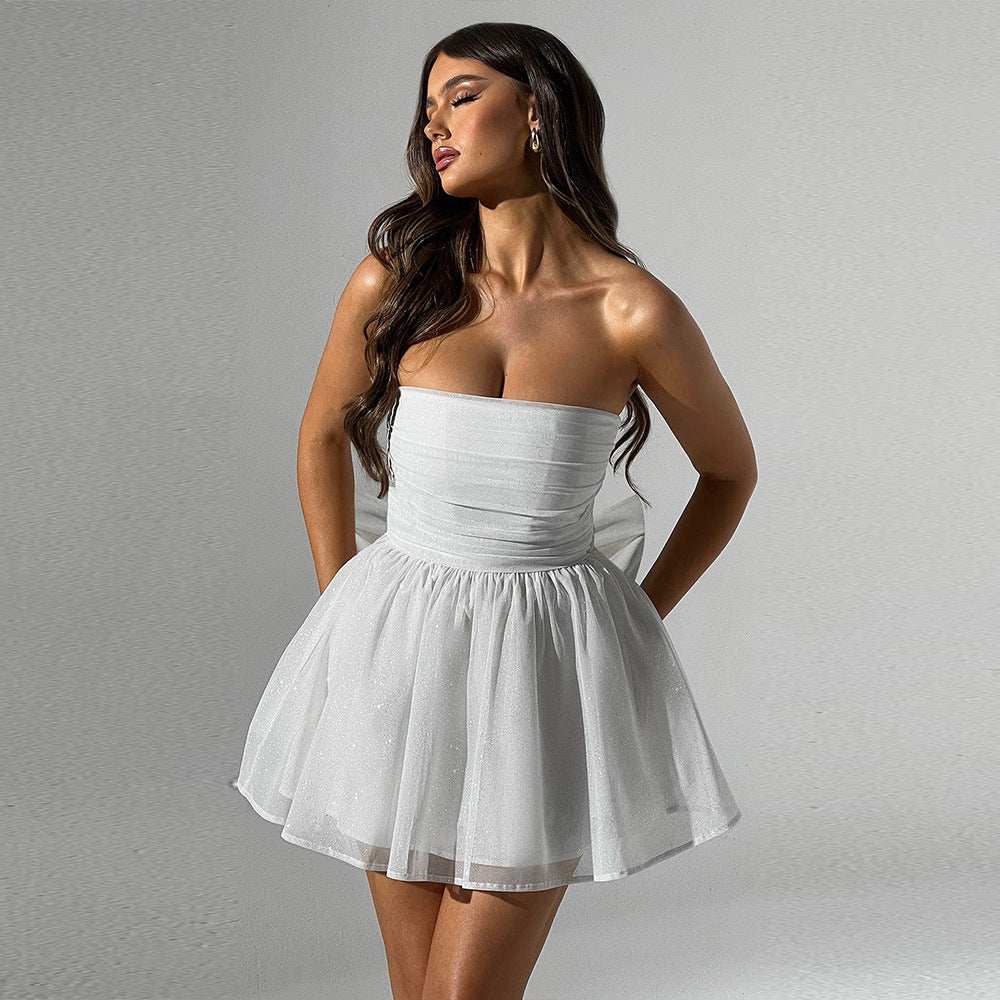 Woman wearing white tube top lace dress with off-neck mesh stitching and short skirt