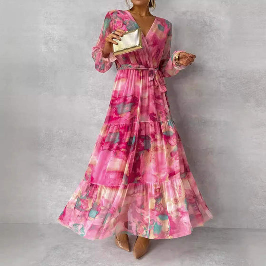 Woman wearing rose red long-sleeved floral print chiffon maxi dress with V-neck and pleated high-waisted big swing skirt