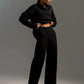 Woman wearing black fall winter two piece set loose collar sweater and pants