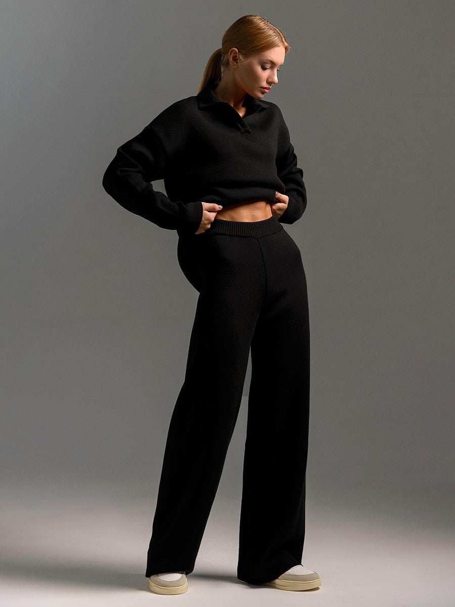 Woman wearing black fall winter two piece set loose collar sweater and pants