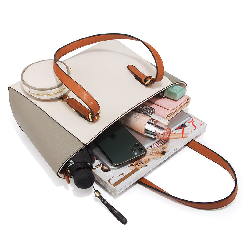 Large capacity three-in-one saffiano bag in white with brown handles, showing spacious interior with personal items inside