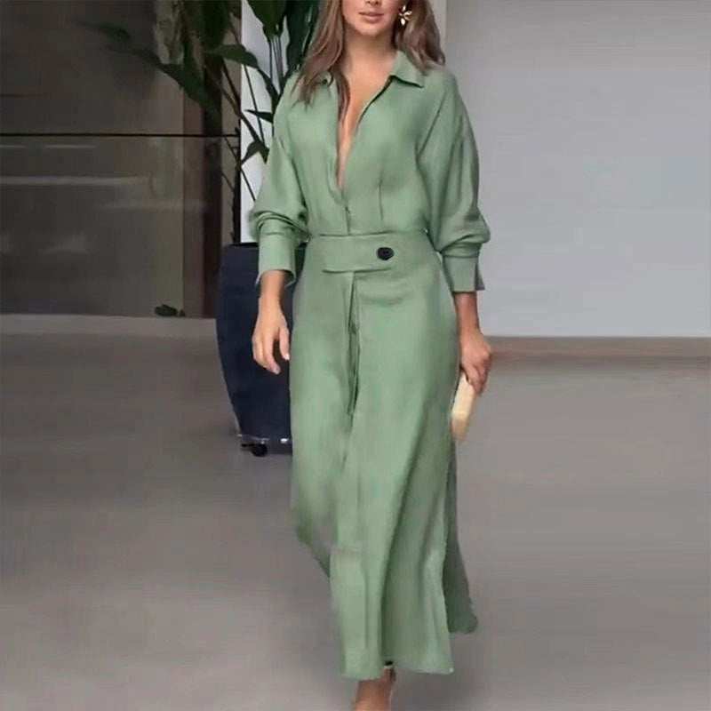 Woman wearing a green elegant tied solid color waisted long-sleeved shirt dress with asymmetrical skirt and pockets
