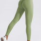 Women's high waist seamless yoga pants in solid green with scrunch butt and elastic fit