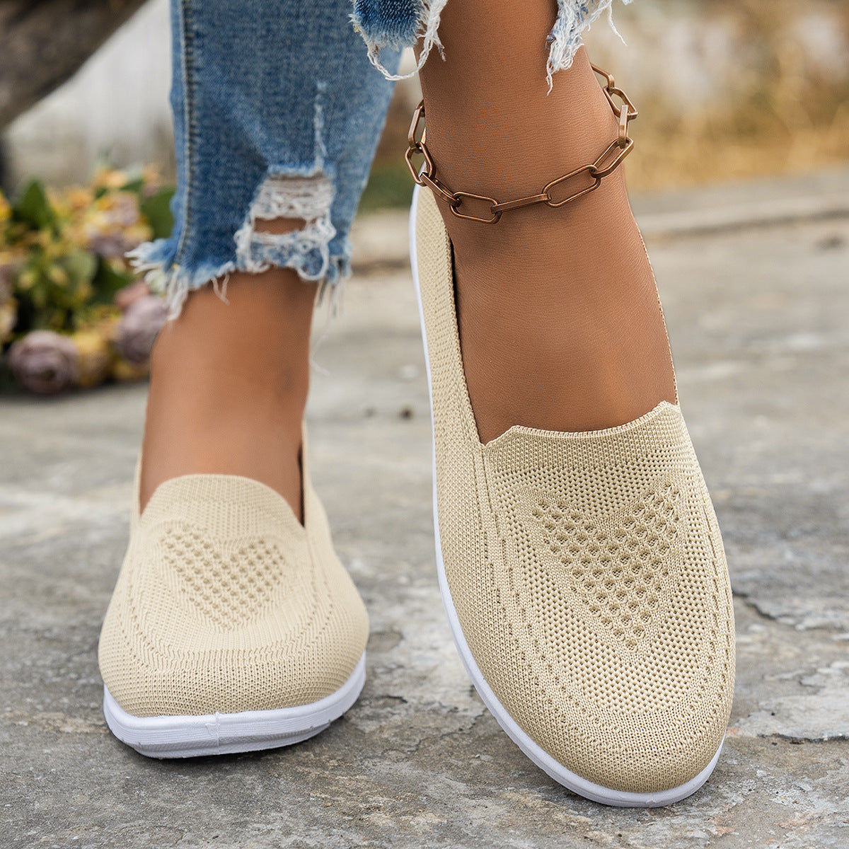 Beige mesh casual women's summer shoes with low flat heel worn with ripped jeans and ankle chain