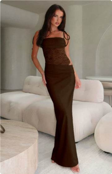 Woman wearing brown Y2K lace suspender dress standing indoors near sofa