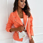 Woman wearing stylish coral zip-up lapel jacket with pockets and white pants