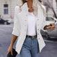 Woman wearing white winter fashion stand collar double breasted cardigan jacket with long sleeves and jeans outdoors