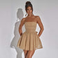 Woman wearing beige tube top lace dress with short skirt and back bow-knot detail