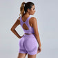 Woman wearing purple seamless yoga set women's vest and high waist shorts workout sportswear