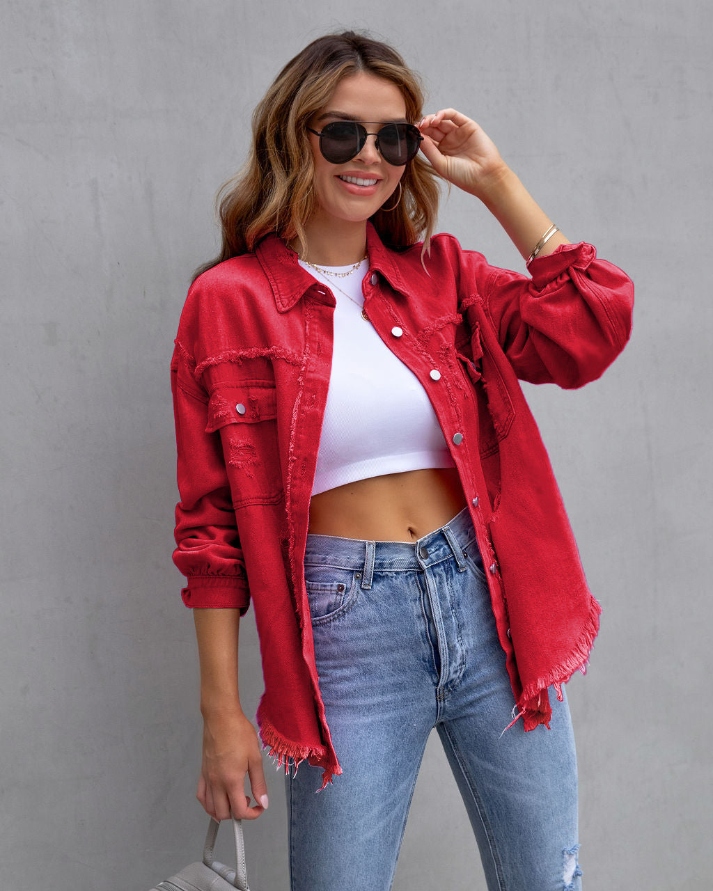 Women's red ripped shirt jacket worn with sunglasses and blue jeans, casual autumn spring top
