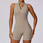 Women’s sleeveless fitness yoga jumpsuit with front zipper and backless design in beige shorts style