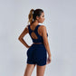 Woman wearing navy seamless yoga set women's vest and high waist shorts workout sportswear