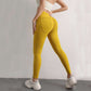 Woman wearing high waist hip lift yellow yoga leggings with back pockets and ruched design