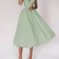 Woman wearing sexy V-neck suspender A-line summer dress in light green