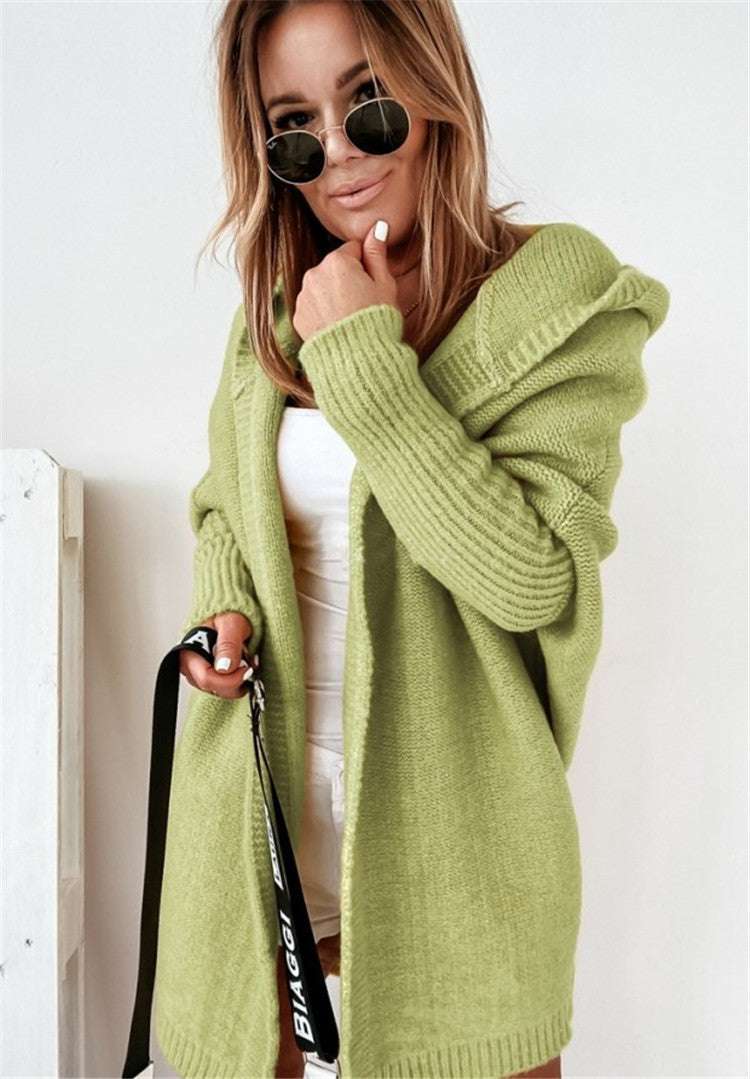 Woman wearing oversized loose bat sleeve hooded cardigan in mint green