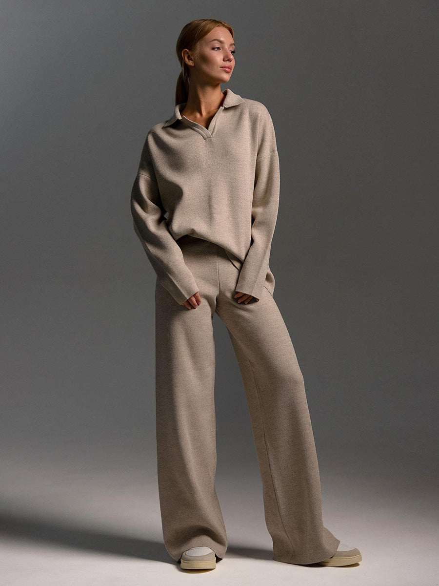 Woman wearing beige fall winter two piece set with loose collar sweater and wide-leg pants
