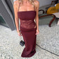 Woman wearing a sexy Y2K lace suspender dress in burgundy with a high waist and long skirt, perfect for party or evening events