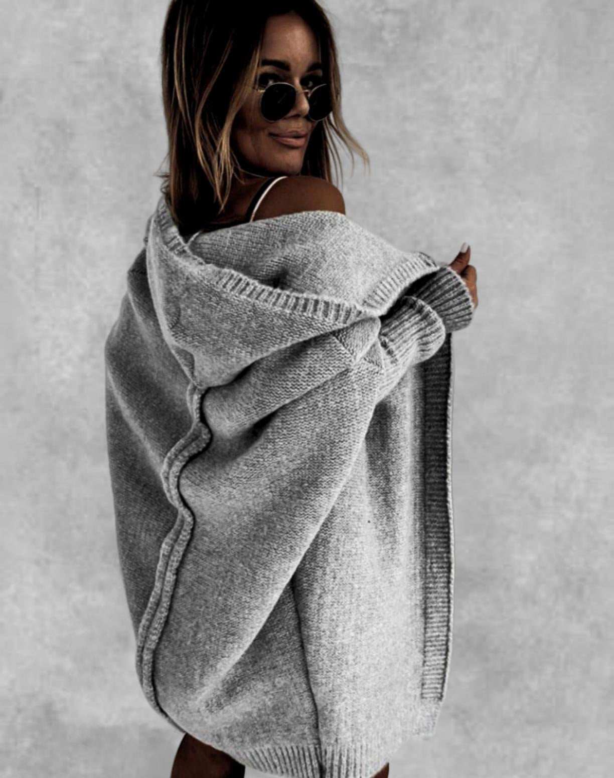 Woman wearing oversized gray bat sleeve hooded cardigan sweater with loose fit and solid color