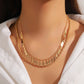 Gold multi-layer braided chain necklace with disc droplets and waterdrop-shaped tassels on a woman's neck