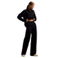Woman wearing black fall winter two piece set with loose collar sweater and wide-leg pants