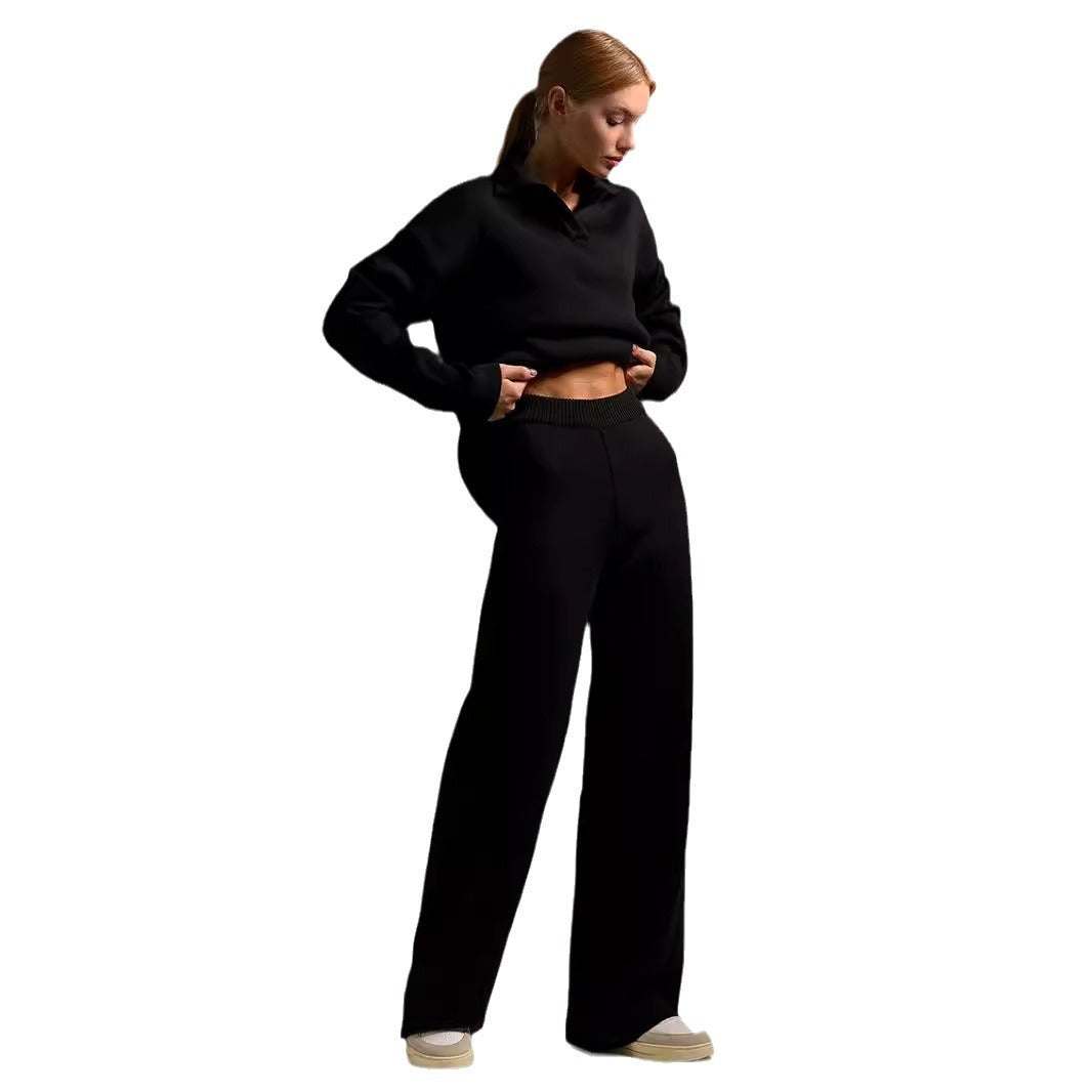 Woman wearing black fall winter two piece set with loose collar sweater and wide-leg pants