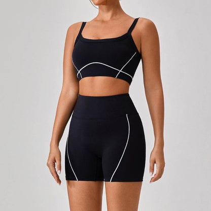 Women's black outdoor sports yoga suit with spaghetti straps and contrast white lines, fitted two-piece fitness outfit.