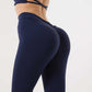 Woman wearing navy seamless high waist yoga pants with scrunch butt and elastic waistband