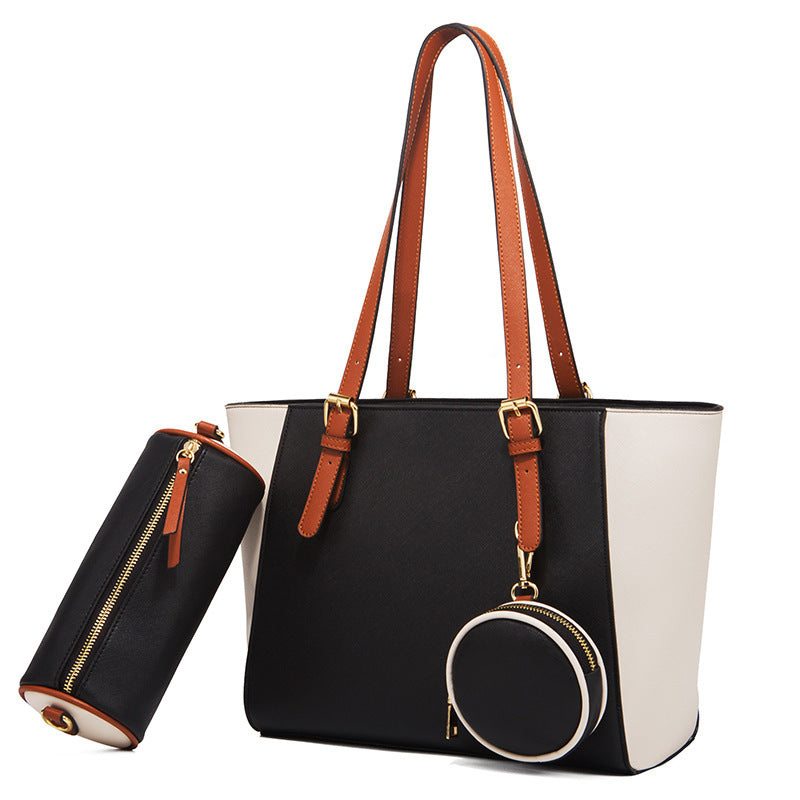 Large capacity three-in-one saffiano bag with black, white, and brown accents, double shoulder straps, and bucket shape