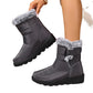 Plus size women's black snow boots with flat heels, buckle fastening, and fur trim for warmth and comfort