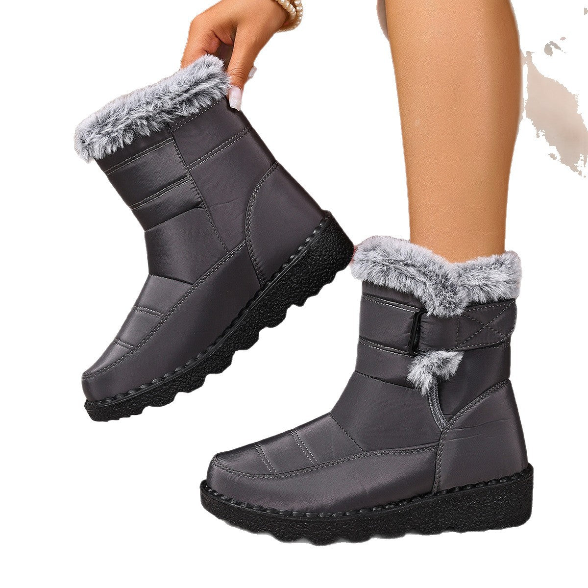 Plus size women's black snow boots with flat heels, buckle fastening, and fur trim for warmth and comfort