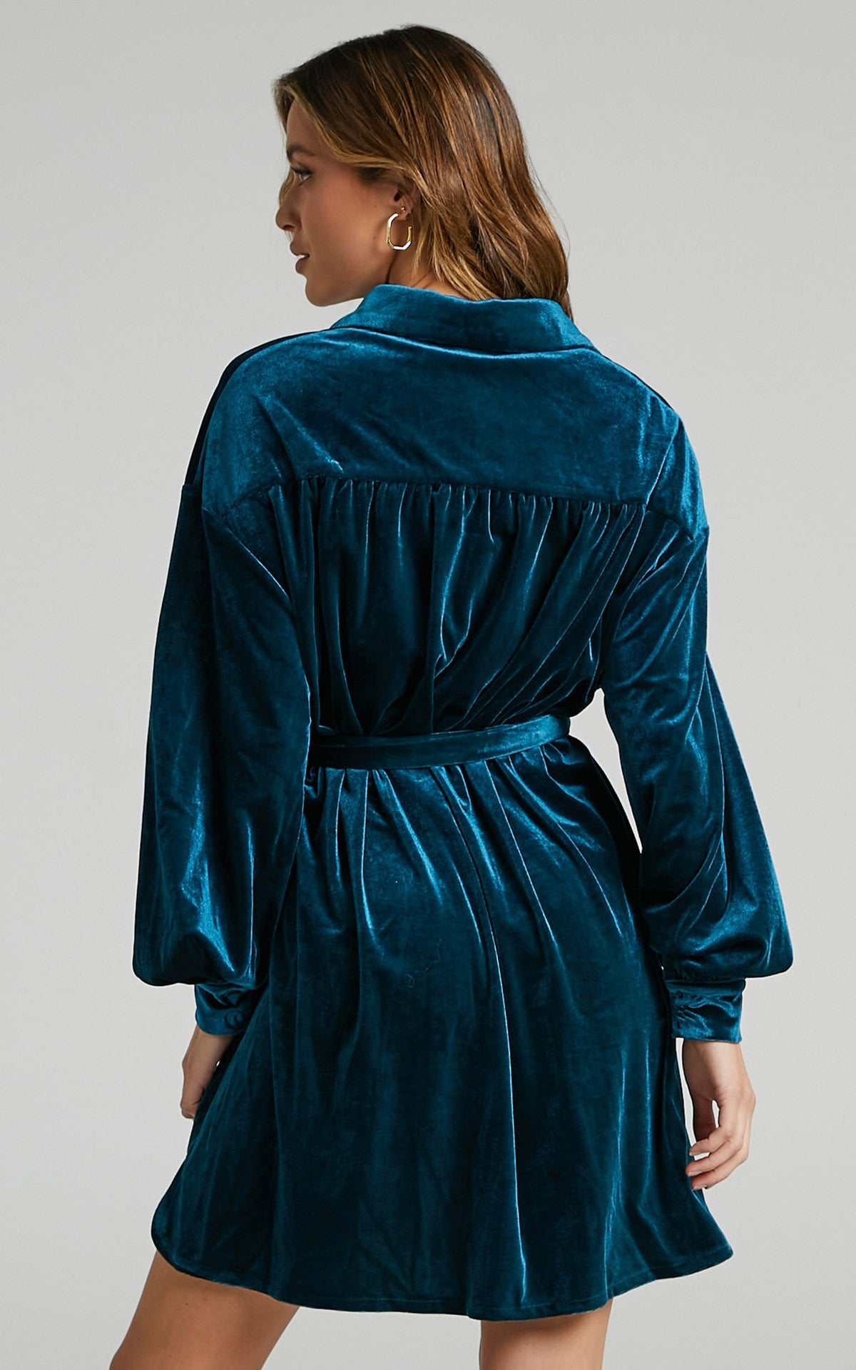 Back view of a woman wearing a blue green velvet long shirt dress with lapel collar and loose waist, Women's Gold Velvet Dress