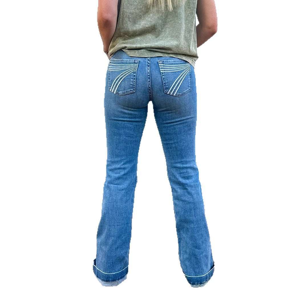 Slim fit elastic mid-waist slightly flared blue denim jeans with embroidered pockets shown from back