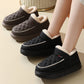 Pair of black and brown winter plush cotton shoes with thick rubber soles worn indoors and outdoors