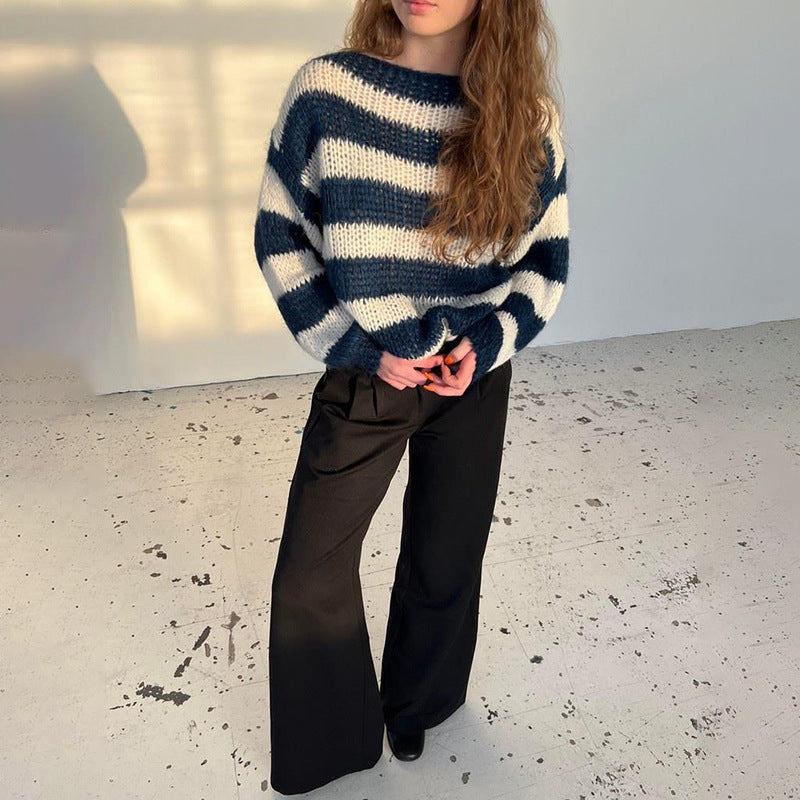 Loose striped pullover sweater in navy and white, worn with black wide-leg pants, casual knitted long-sleeve top for women