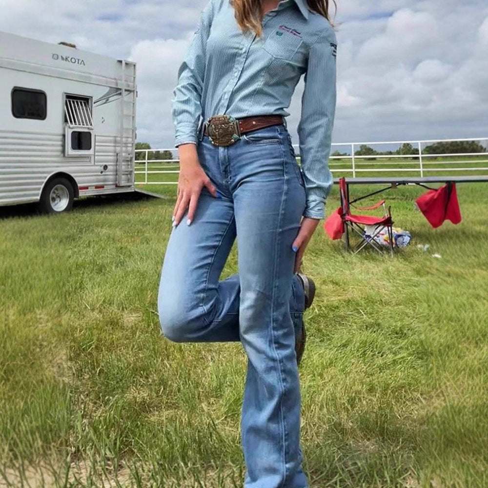 woman wearing slim fit elastic mid-waist slightly flared blue denim jeans outdoors