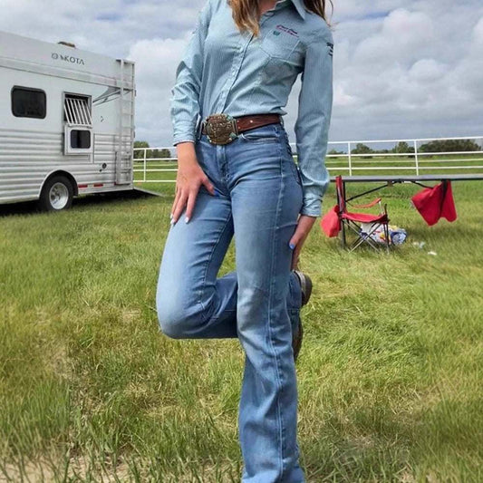 woman wearing slim fit elastic mid-waist slightly flared blue denim jeans outdoors